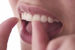 Close up of woman flossing